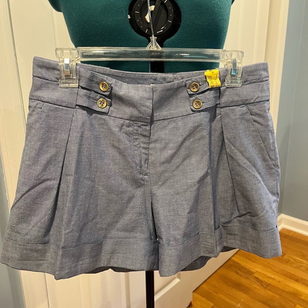 81 Poppies chambray blue shorts with gold button & strap detail.